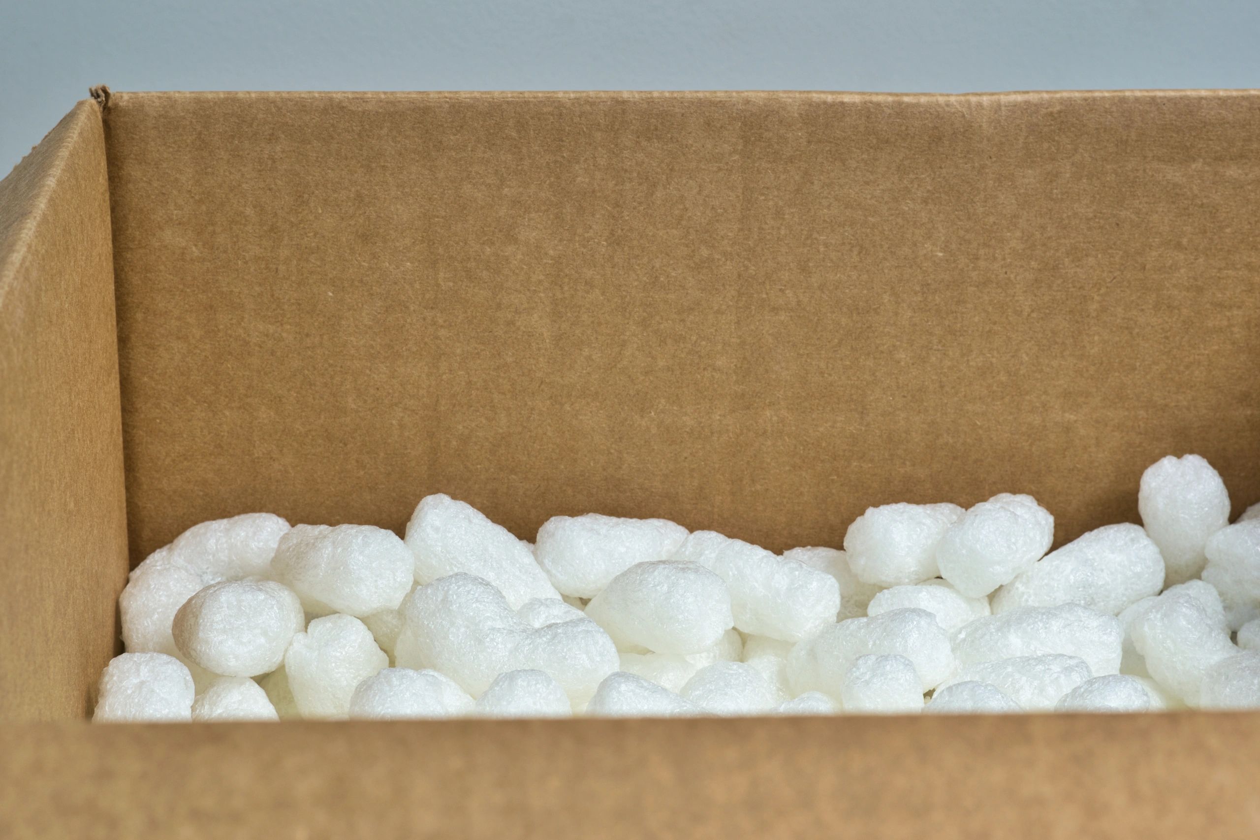 Protective foam packaging material in a carton, illustrating EPS cushioning applications