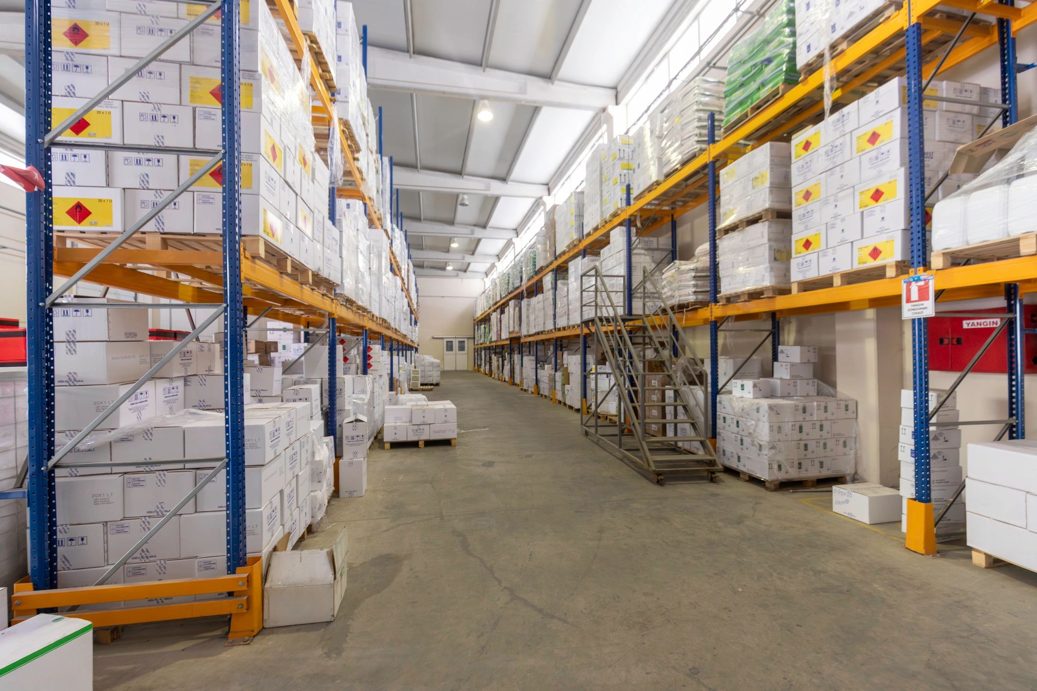 Organized warehouse shelves stacked with boxes for storage and dispatch
